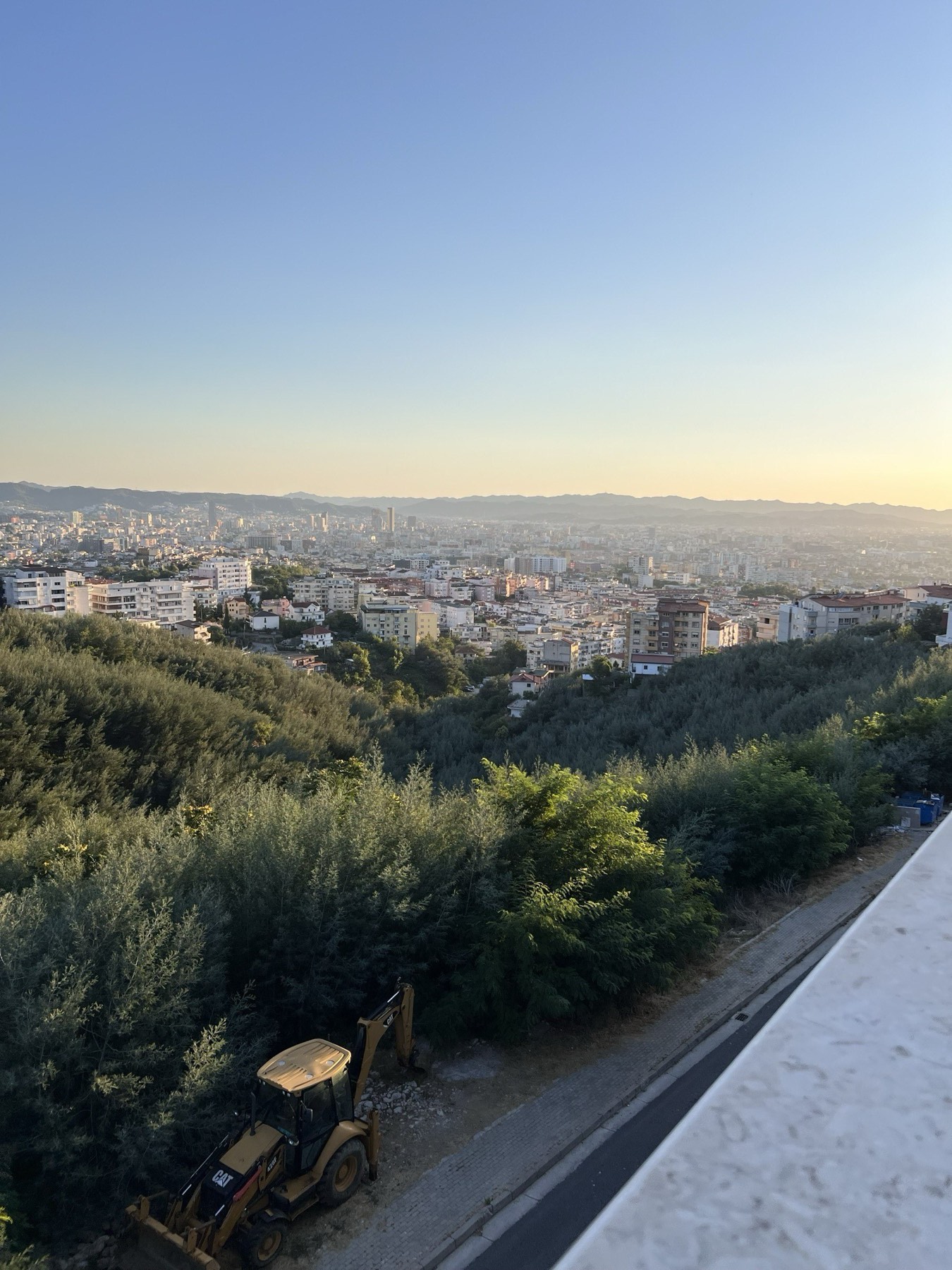 Sunset view over the city of Tirana and the surrounding hills, seen from the apartment above Fresku